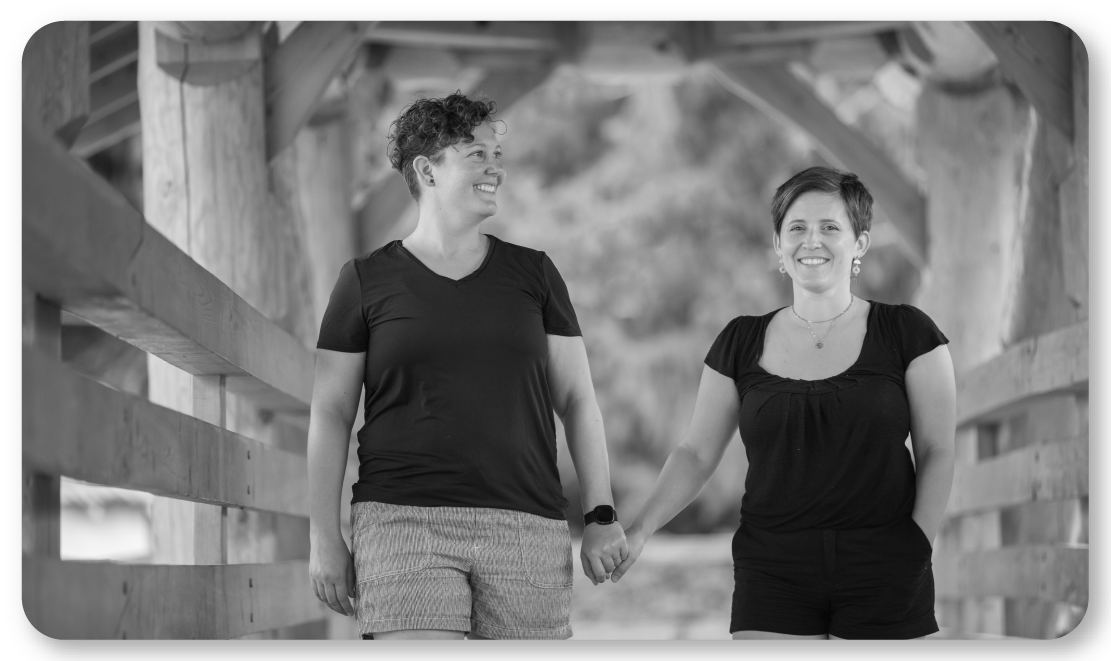 black and white image of couple holding hands 