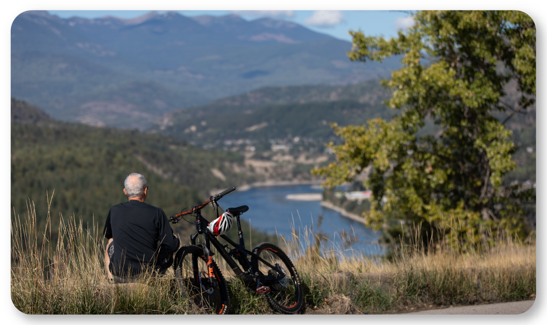 man with bike looking at mountain landscape